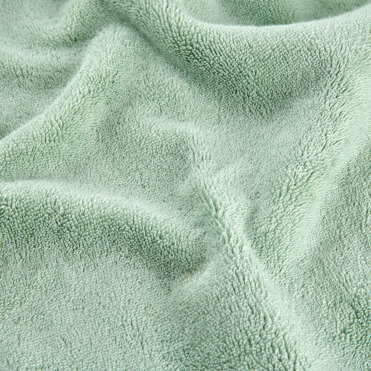 Green bamboo towel set showing soft textured fabric surface detail in close-up view